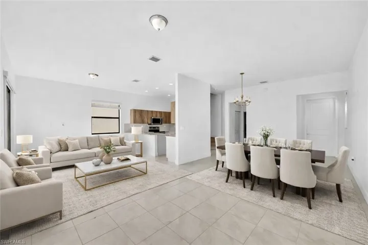 VIRTUALLY STAGED-Living/Dining area featuring hanging lights and light tile patterned flooring