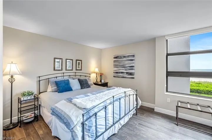 Bedroom with wood finished floors and baseboards