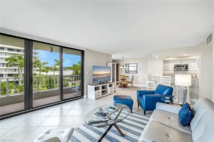 Living room with plenty of natural light and light tile patterned floors