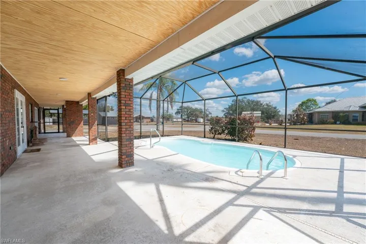 Outdoor pool with a lanai, a patio area