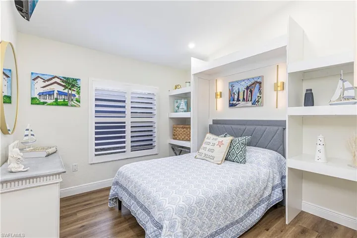 Middle Guest Bedroom with custom built in shelves being offered furnished