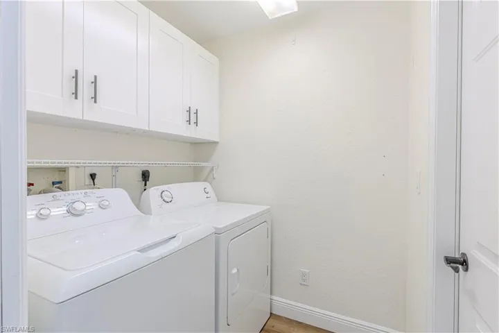 Laundry room with extra white cabinetry great for storage
