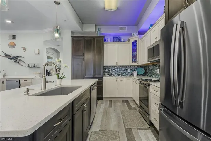Large kitchen with latest design and appliances open to living areas.