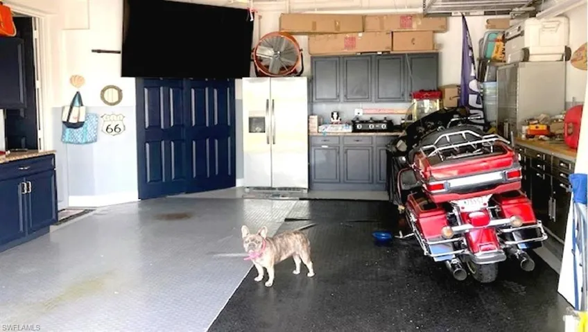 2-car Garage has lots of storage and plenty of "man cave" decor.
