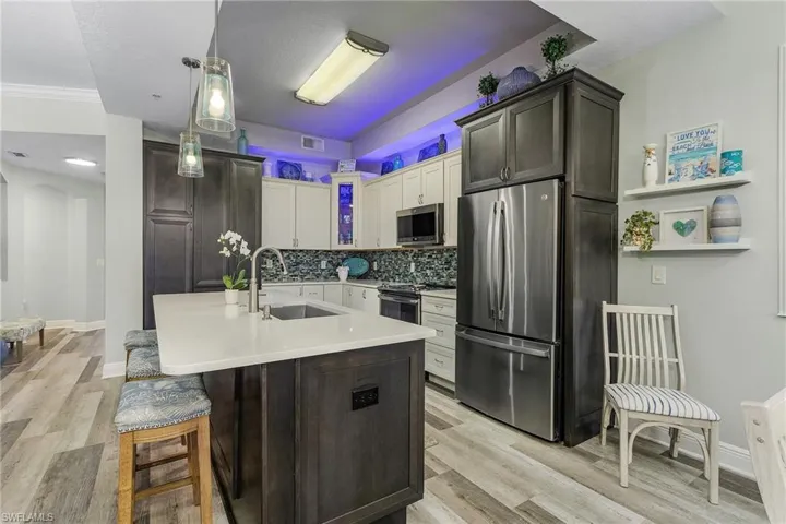 Large kitchen with latest design and appliances open to living areas.