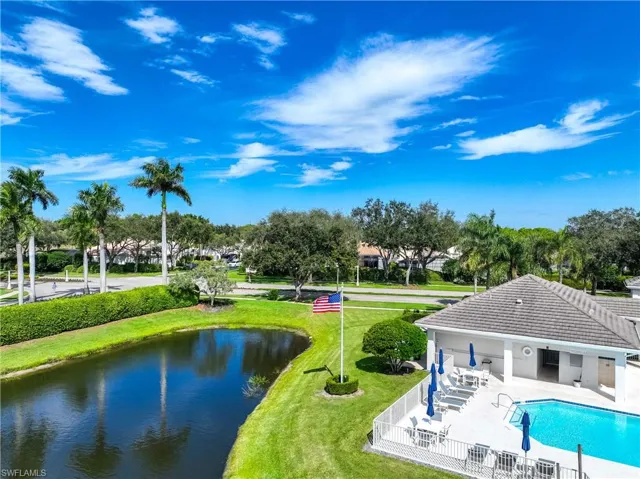 Surrounding community with a patio area, a swimming pool, and a water view
