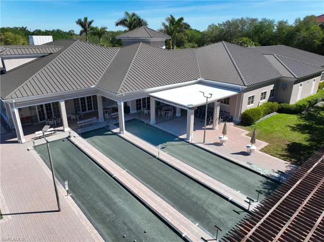 Back of house with a patio area and a metal roof
