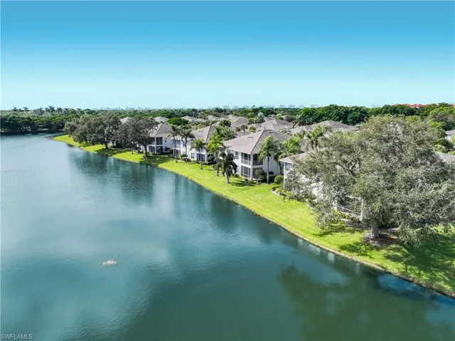 Aerial view of a nearby body of water and a tree filled landscape