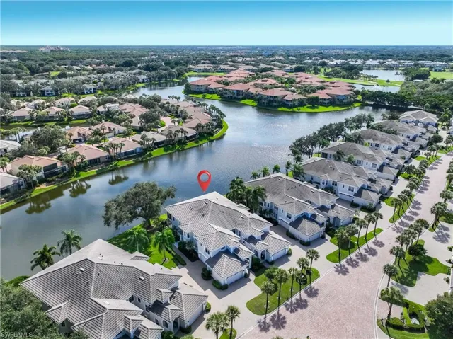 Aerial view of residential area featuring a large body of water