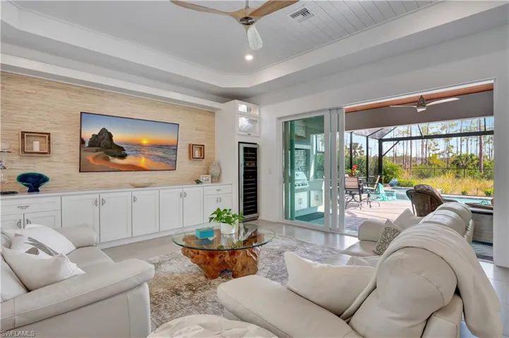 Tiled Living Room with Ceiling Fan and Pocket Slider to Covered Lanai