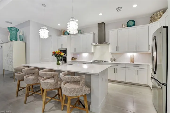 Kitchen featuring Soft Close cabinetry and Drawers as well s offering pendant lighting and stainless steel appliances