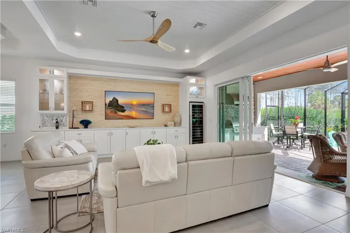 Living Room with Wine Cooler, Tray Ceiling, and a TLons of Natural Light and Breeze