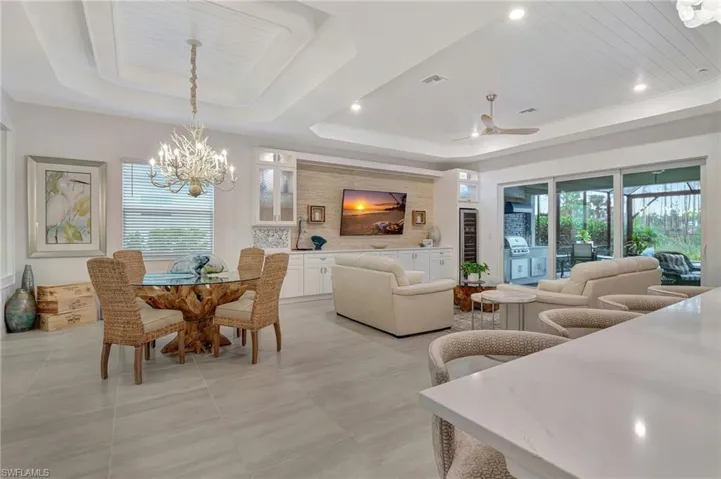 Dining Area featuring Custom Chandelier, and Tray Ceiling