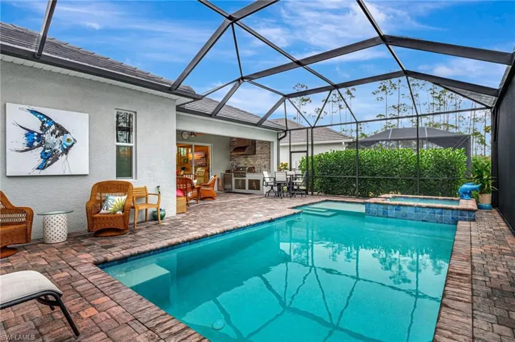 View of Pool featuring  an in ground hot tub, a patio area, exterior kitchen