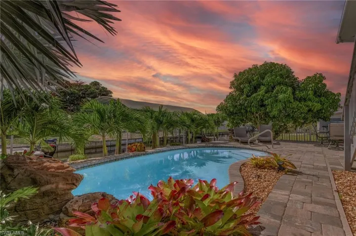Pool at dusk with a patio area