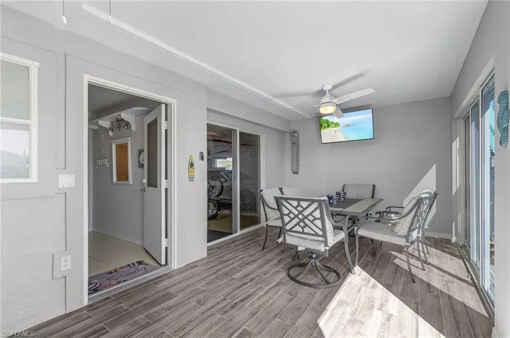 Sunroom with a healthy amount of sunlight and ceiling fan