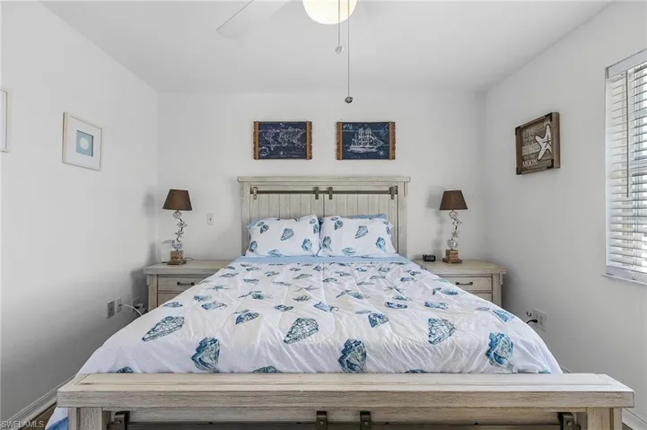 Bedroom featuring ceiling fan and multiple windows