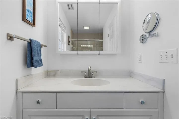 Bathroom with vanity and a shower with shower door