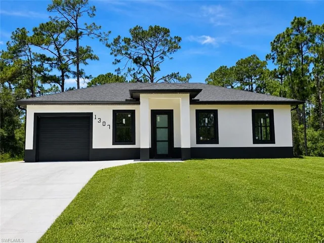 Contemporary stucco exterior with a dark shingle roof and contrasting dark trim