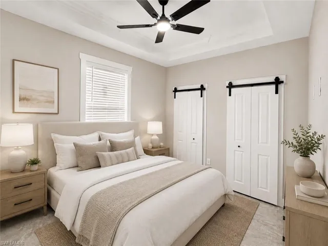 Tray ceiling with a black ceiling fan, complemented by light-toned wall paint