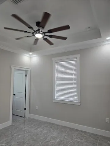 Tray ceiling featuring a contemporary ceiling fan with integrated lighting