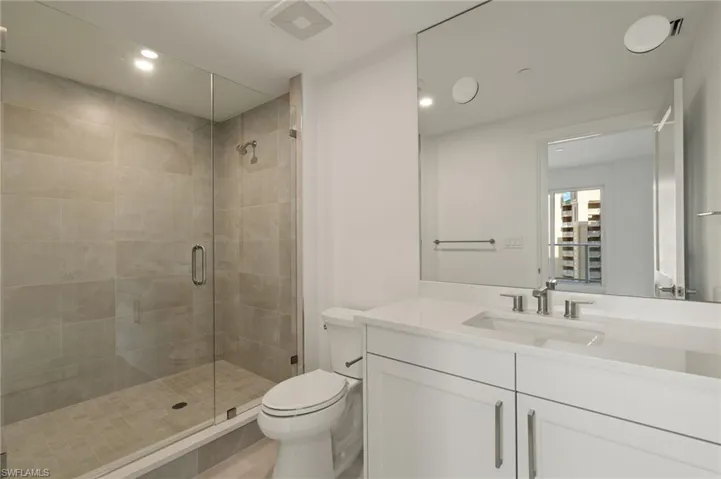 Bathroom 2 with vanity, a stall shower, and recessed lighting
