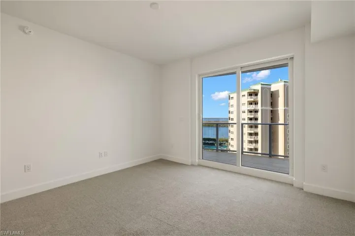 Bedroom 2 features light colored carpeting, and slider to open balcony , gorgeous bay views