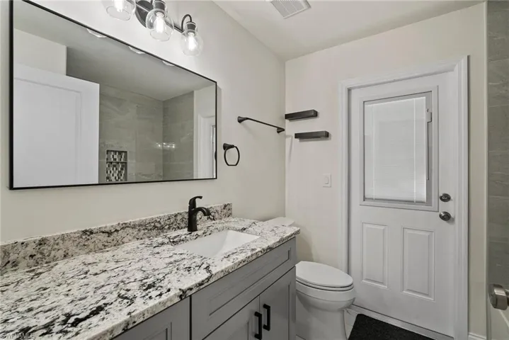 Bathroom featuring vanity and toilet
