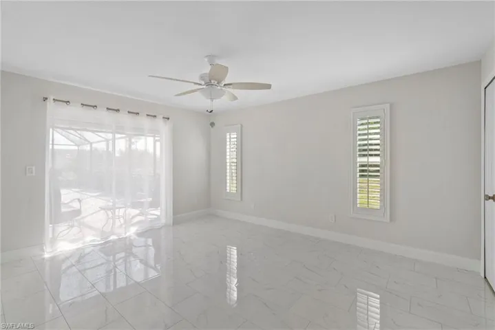 Empty room with a wealth of natural light and ceiling fan