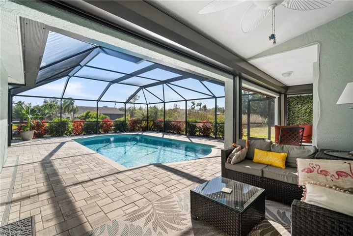 View of swimming pool with a lanai, an outdoor hangout area, ceiling fan, and a patio area