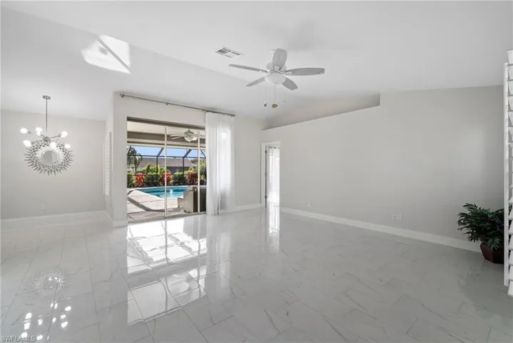 Spare room with vaulted ceiling and ceiling fan
