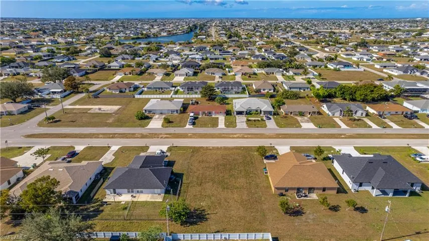 View of property location with nearby suburban area and a nearby body of water
