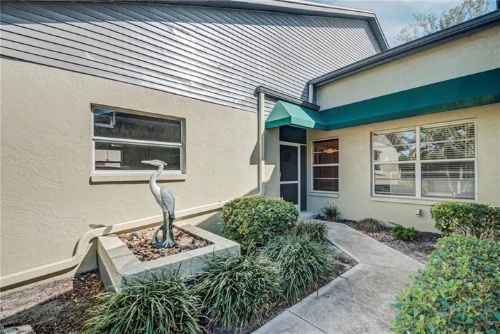 Doorway to property with stucco siding