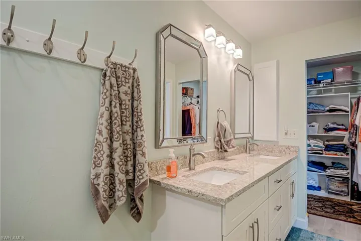 Primary bath with double vanity and a walk in closet