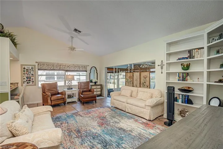 Tiled living room featuring vaulted