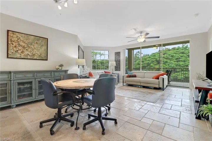 Dining space featuring stone tile flooring and ceiling fan