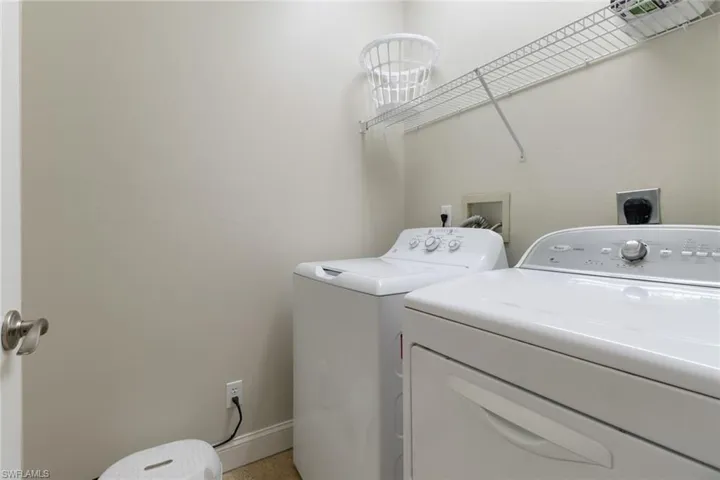 Laundry room with washer and dryer and baseboards