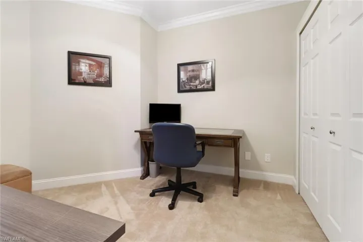 Office with light carpet and crown molding