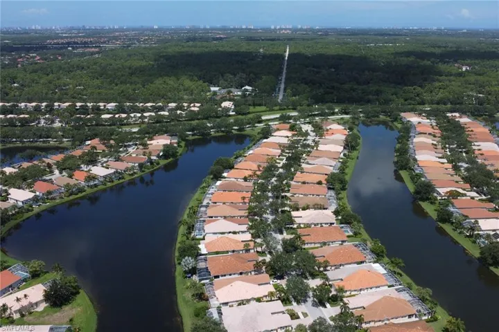 Birds eye view of property with a water view