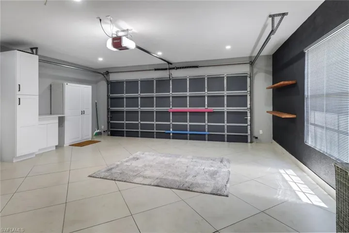 Electric tankless water heater in garage.