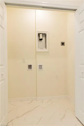 Clothes washing area featuring electric dryer hookup, tile flooring, and hookup for a washing machine