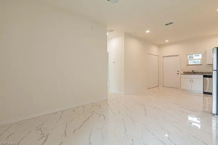 Tiled spare room with sink
