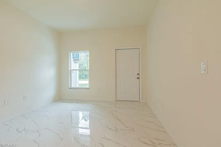 Unfurnished room with light tile floors