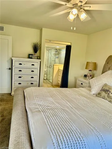 Carpeted bedroom with ceiling fan