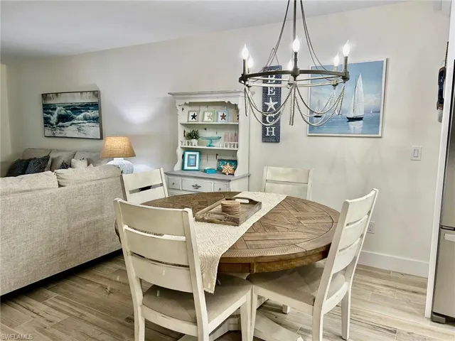 Dining space featuring a chandelier and light hardwood / wood-style flooring