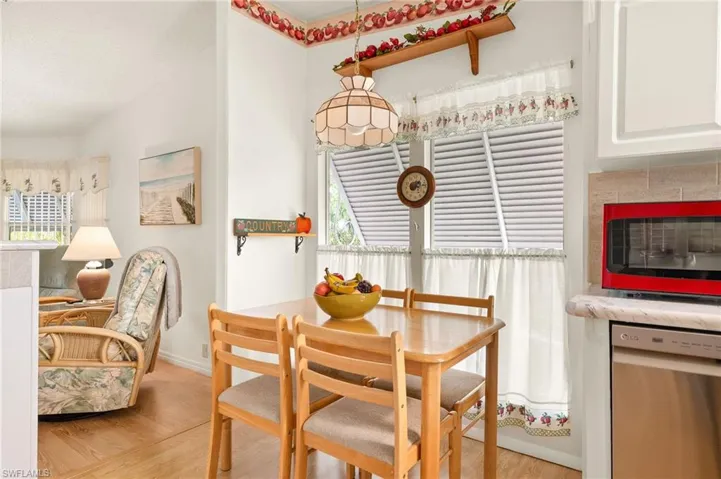 Dining area featuring baseboards, light wood-type flooring, and plenty of natural light