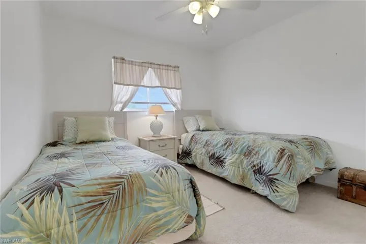 Bedroom featuring ceiling fan and light carpet