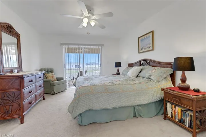 Bedroom featuring access to outside, light carpet, and ceiling fan