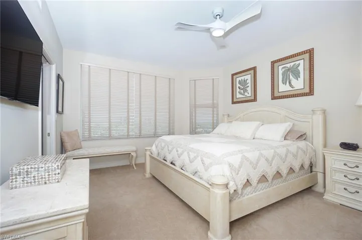 Bedroom featuring light colored carpet and ceiling fan