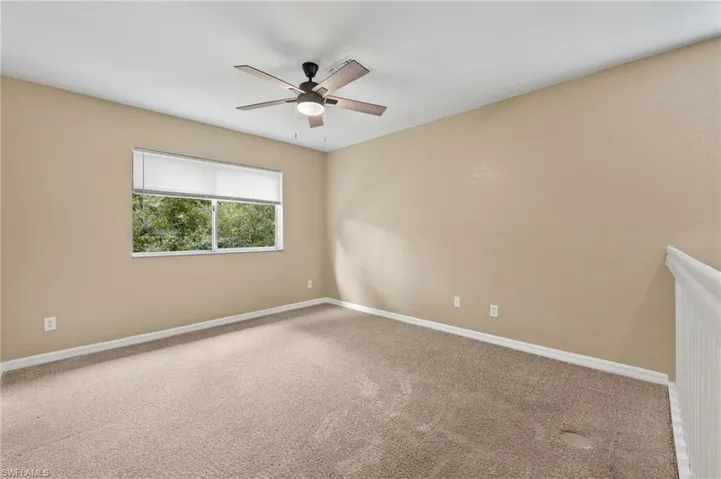 Carpeted LOFT Area with ceiling fan